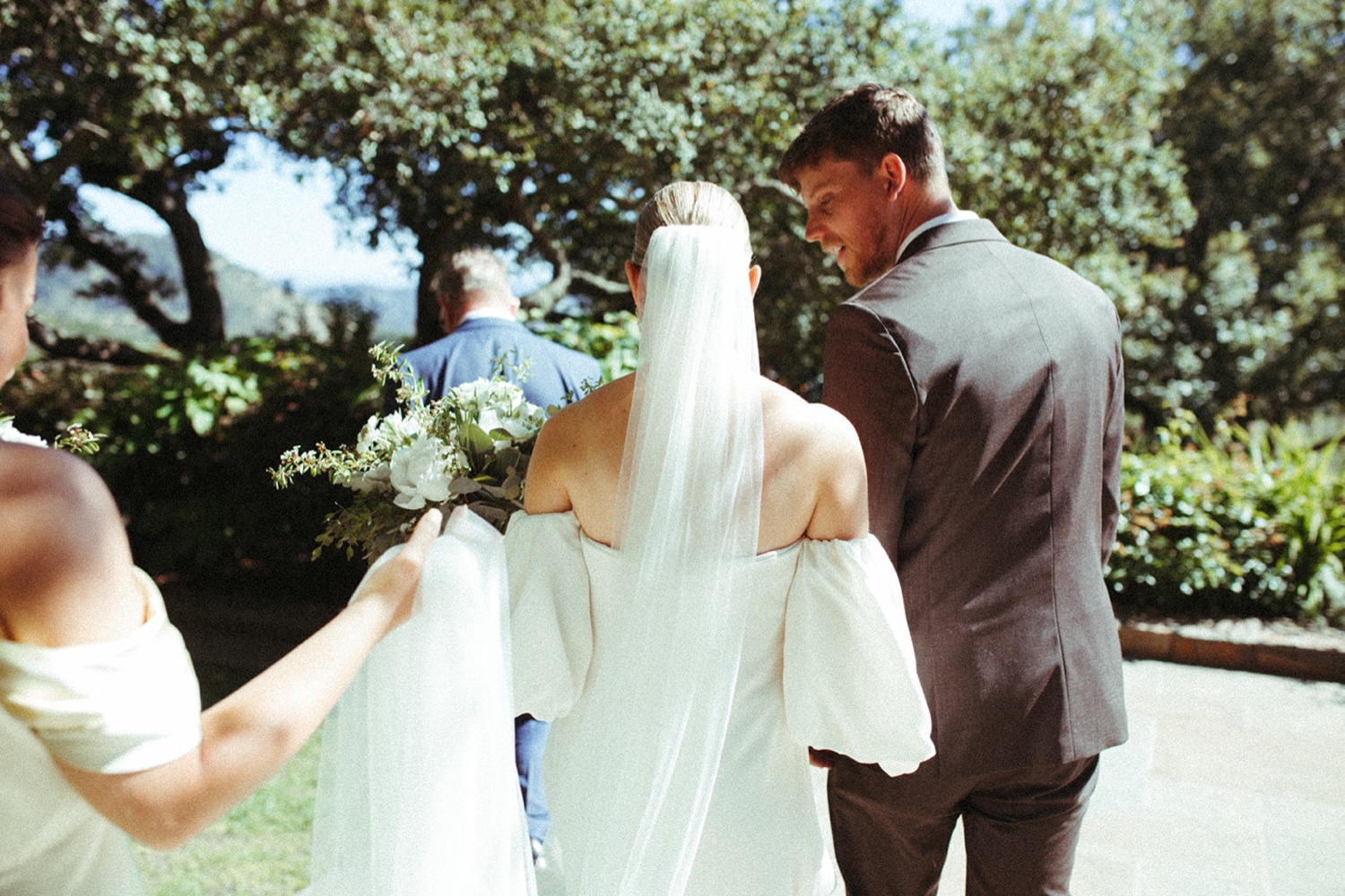 Bride and groom walk away on their wedding day in Napa.