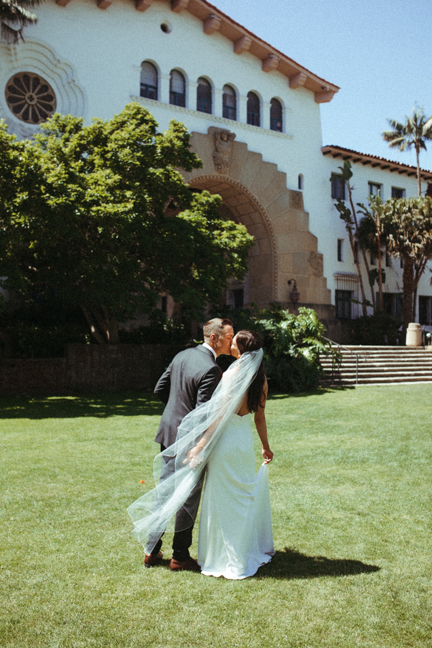 Bride and groom walking to their wedding ceremony at Santa Barbara Courthouse.