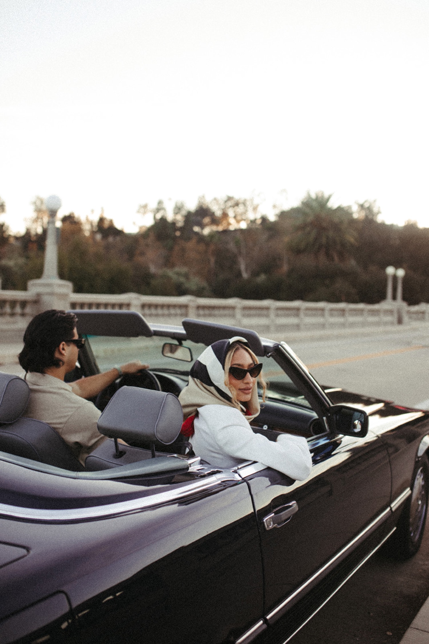 Couple pose with classic car for their engagement photos in Los Angeles