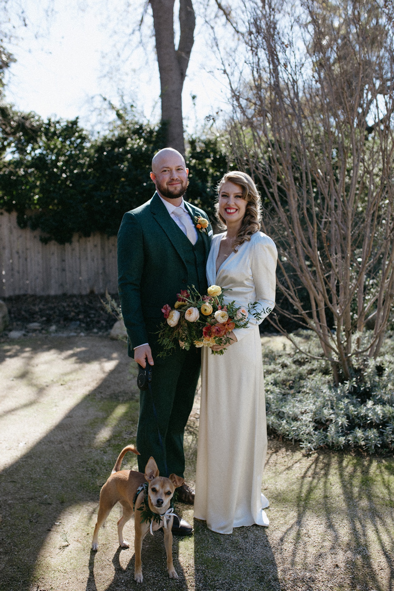 Bride and Groom stand with dog on their wedding day in Ojai