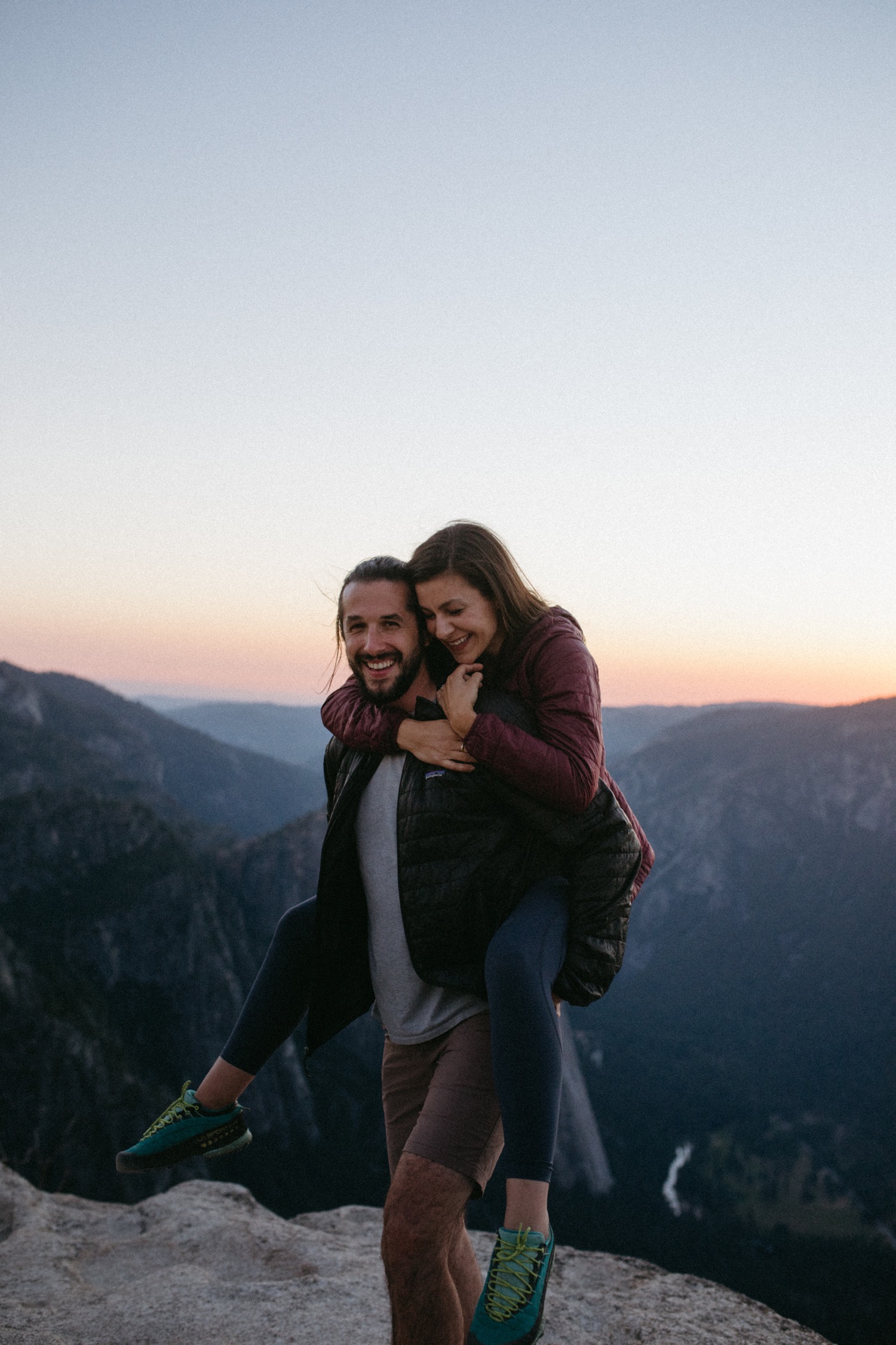 Couple hug during their engagement photos in Yosemite National Park.