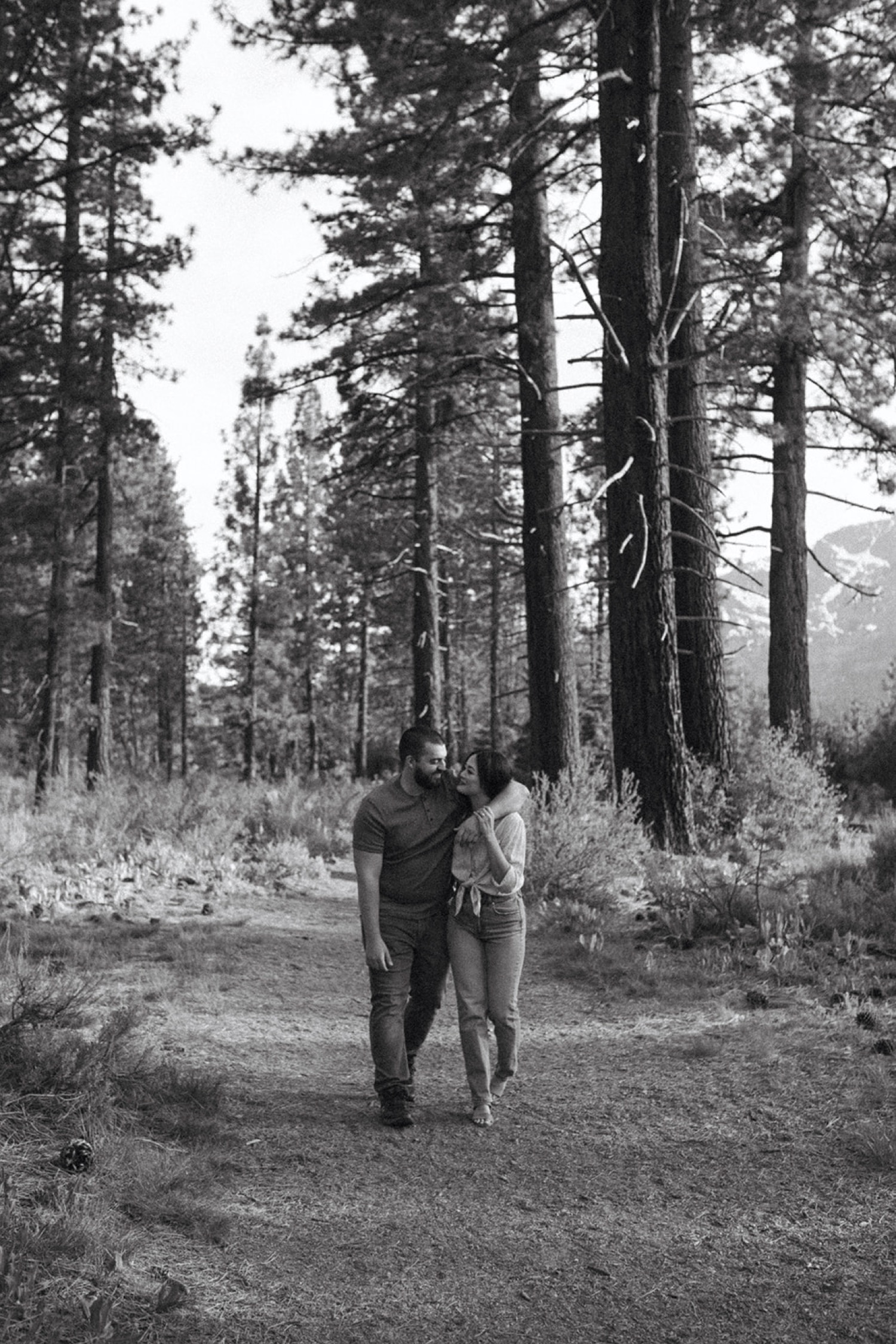 Couple walk arm and arm in South Lake Tahoe during their engagement photo session.