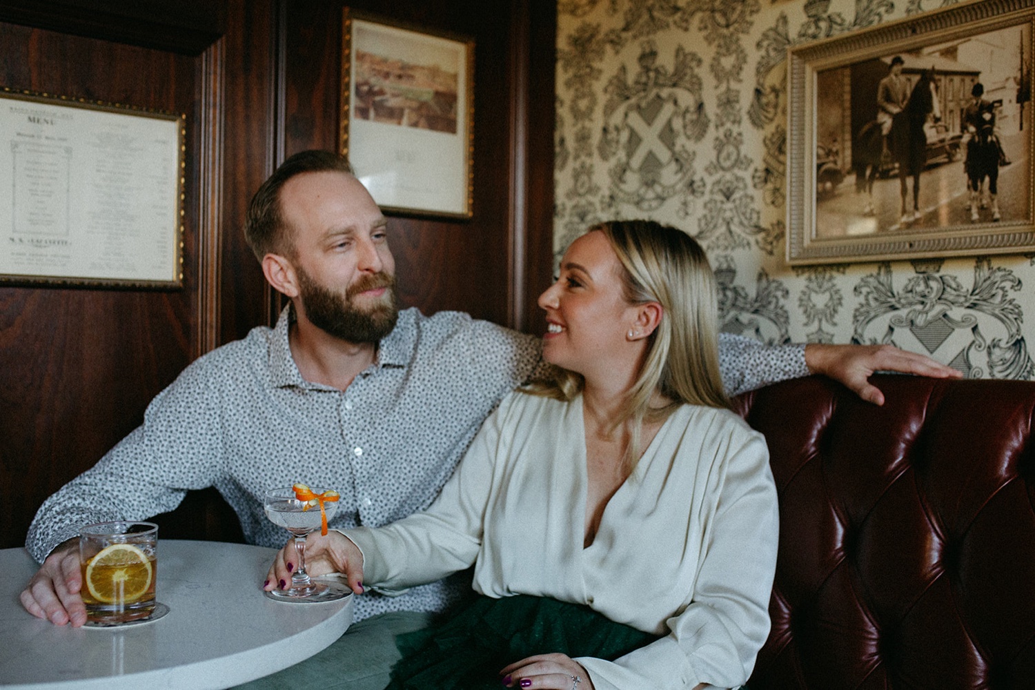 Couple enjoy a drink together during their engagement photos in San Francisco